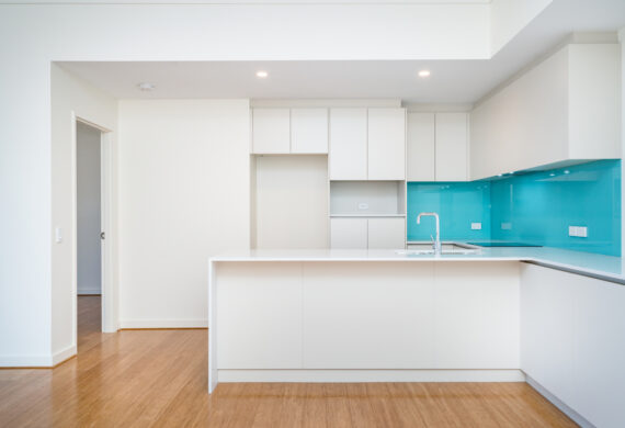 A kitchen with glass splashbacks