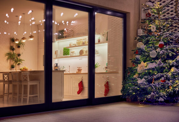 Shot of a glass door where you can see a Christmasy home