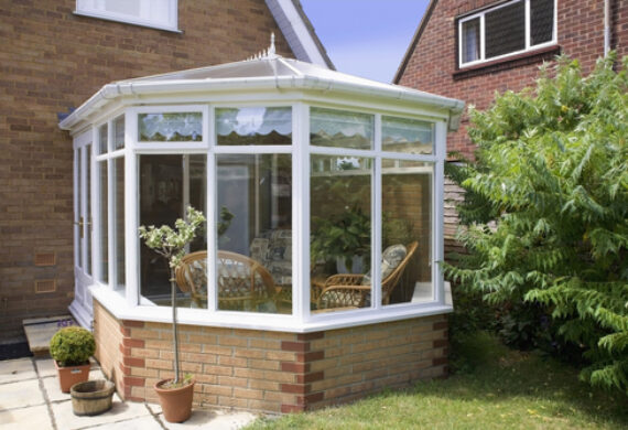 A conservatory with white frames