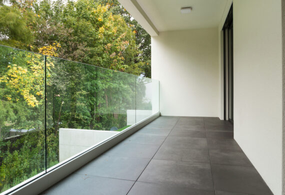 Shot of a balcony with green foliage over it